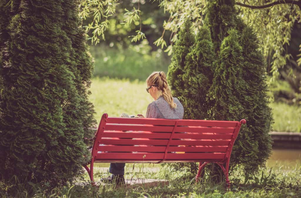 girl reading on a bench