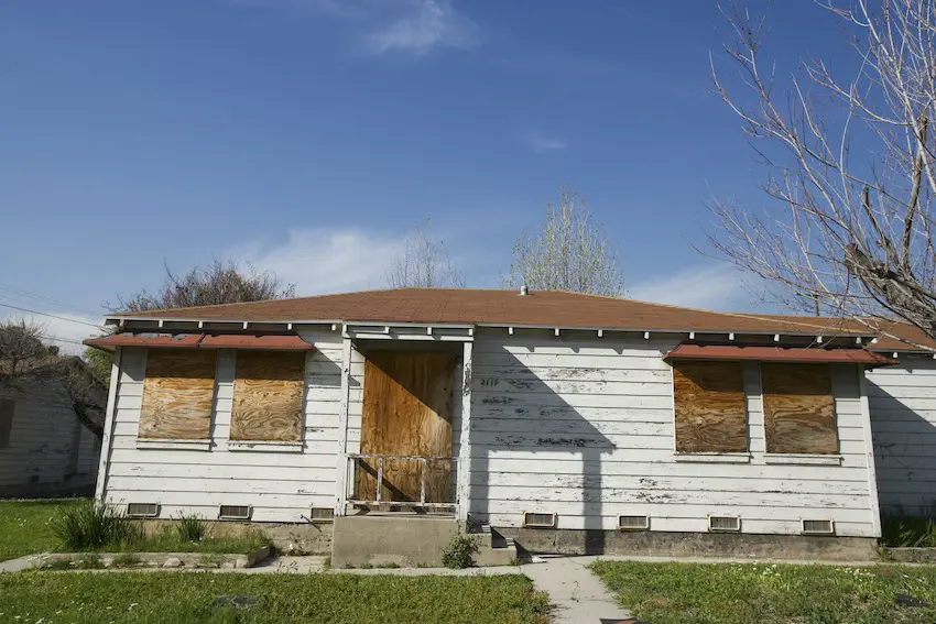 an old wooden boarded up house