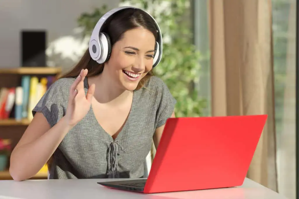 woman using a headset to teach english online