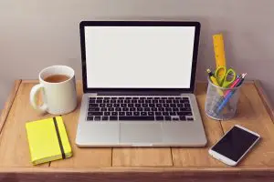 make money online in the UK: a laptop and coffee on a desk