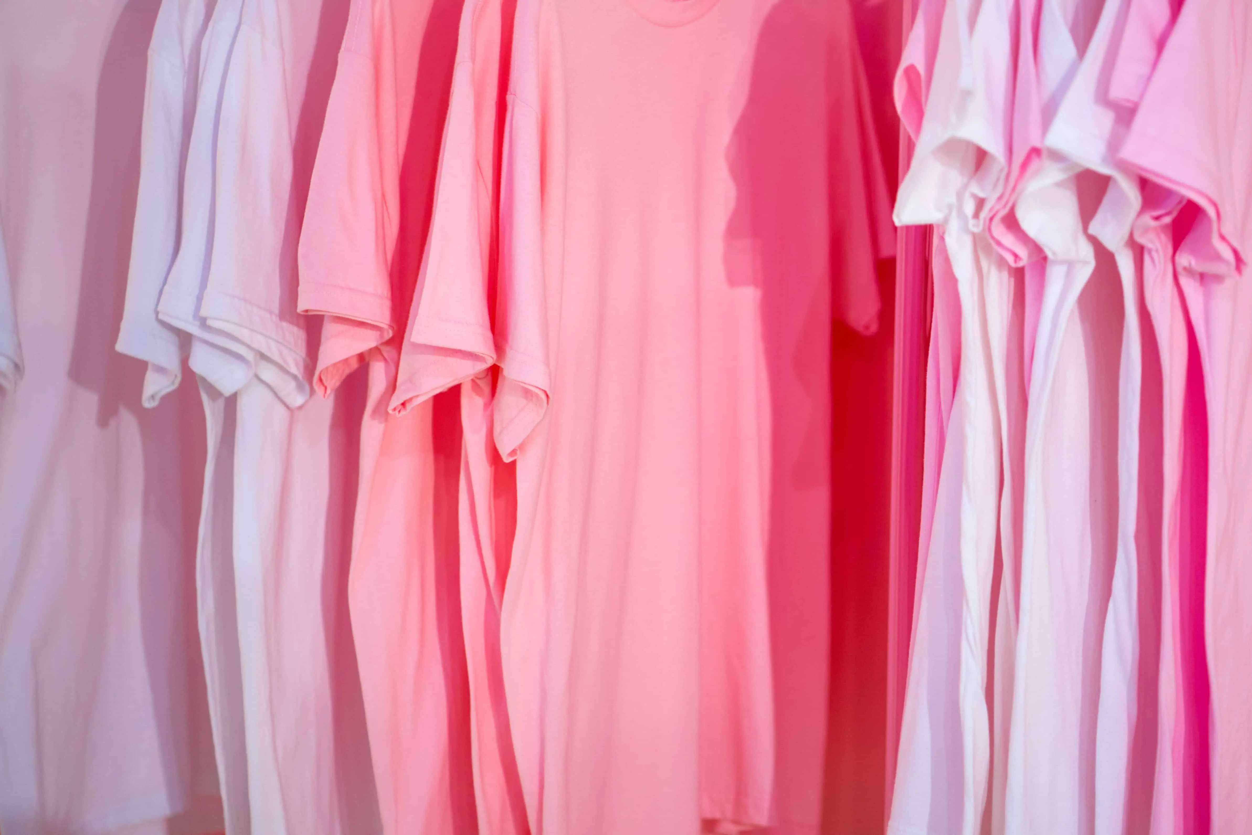 a row of pink t shirts. sell t shirts to make money online!